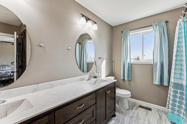 230 Newspaper Run NE, Kimball, MN 55353 - full bathroom featuring double vanity, a textured ceiling, toilet, marble finish flooring, and baseboards