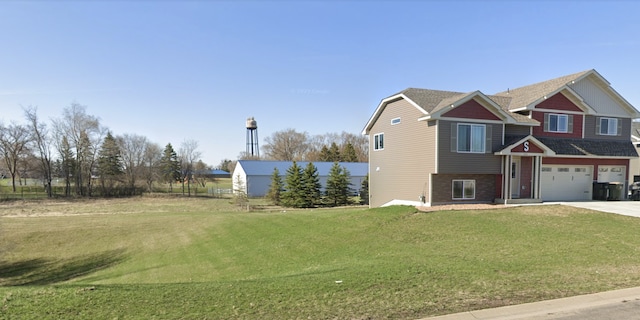 230 Newspaper Run NE, Kimball, MN 55353 - view of front of home with concrete driveway, an attached garage, and a front lawn