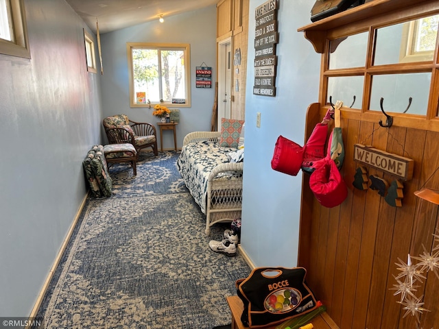 sitting room featuring lofted ceiling, baseboards, and carpet floors