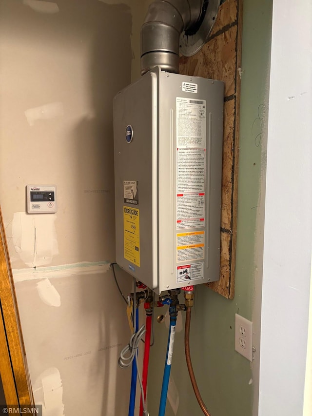 utility room featuring tankless water heater