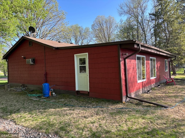 view of outbuilding with a wall mounted AC
