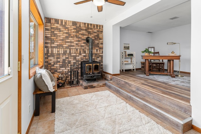 332 Riverside Ave S, Sartell, MN 56377 - living area featuring ceiling fan, a wood stove, and baseboards