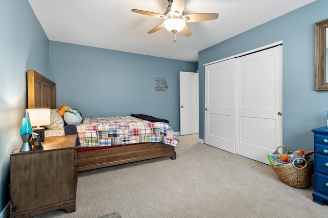 carpeted bedroom featuring a closet and a ceiling fan