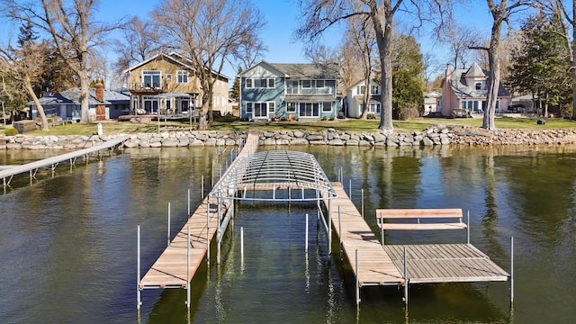 dock area featuring a water view and a residential view