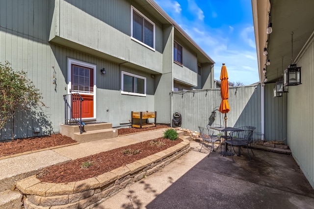 exterior space with fence and outdoor dining space