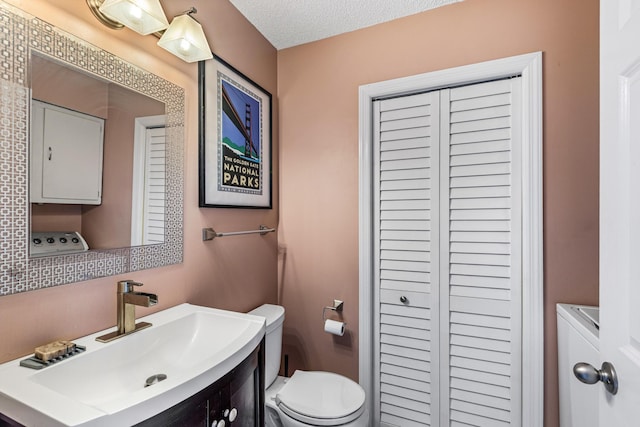 bathroom with toilet and vanity