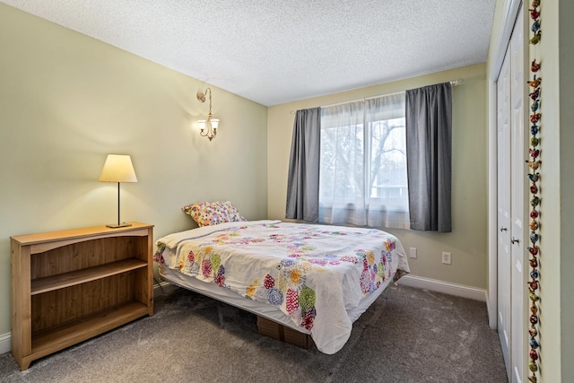 bedroom featuring a textured ceiling, baseboards, and carpet