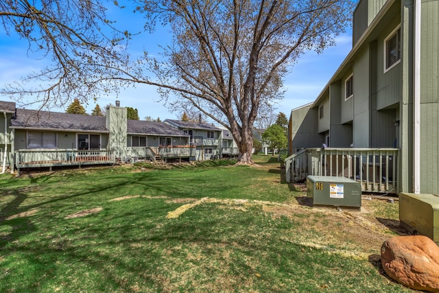 view of yard with a residential view and a wooden deck