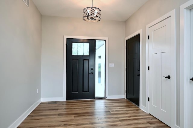 633 Manheim Ave, Saint Charles, MN 55972 - foyer with wood finished floors, baseboards, and a chandelier