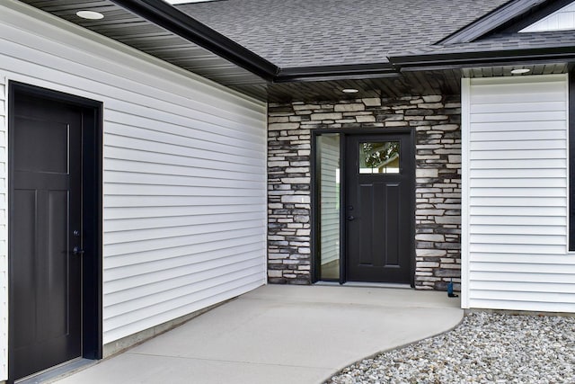 633 Manheim Ave, Saint Charles, MN 55972 - entrance to property with a shingled roof and stone siding