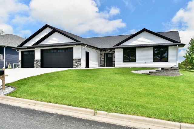 633 Manheim Ave, Saint Charles, MN 55972 - view of front of home with a garage, a front lawn, concrete driveway, stone siding, and a shingled roof