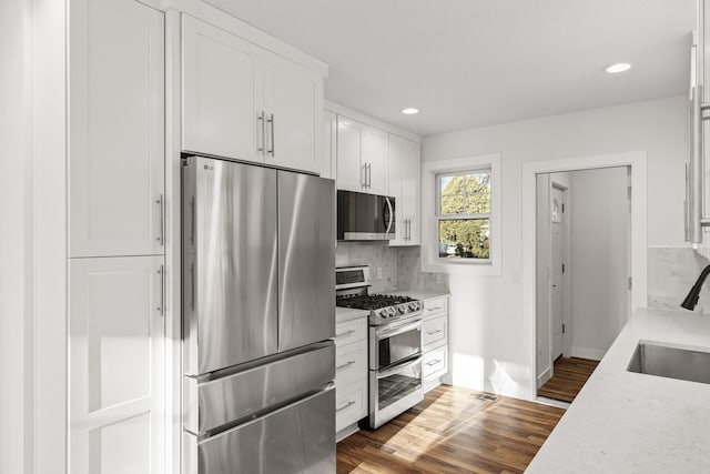 2308 Shadywood Rd, Orono, MN 55391 - kitchen with appliances with stainless steel finishes, a sink, light countertops, tasteful backsplash, and recessed lighting
