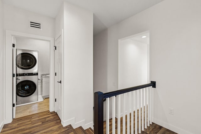 2308 Shadywood Rd, Orono, MN 55391 - hall featuring stacked washer / dryer, an upstairs landing, wood finished floors, and baseboards