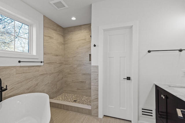 2308 Shadywood Rd, Orono, MN 55391 - bathroom featuring tiled shower, a freestanding tub, recessed lighting, vanity, and tile walls