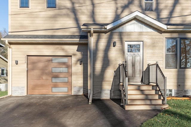2308 Shadywood Rd, Orono, MN 55391 - view of exterior entry featuring driveway and an attached garage