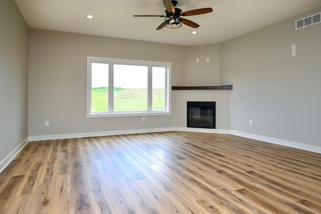 unfurnished living room featuring wood finished floors, visible vents, baseboards, recessed lighting, and ceiling fan