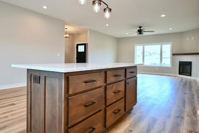 kitchen featuring open floor plan, recessed lighting, light wood-style flooring, and ceiling fan