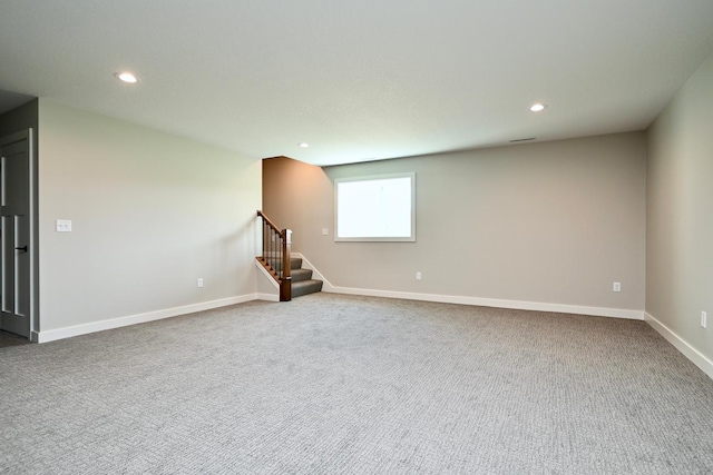 carpeted spare room featuring recessed lighting, stairs, and baseboards