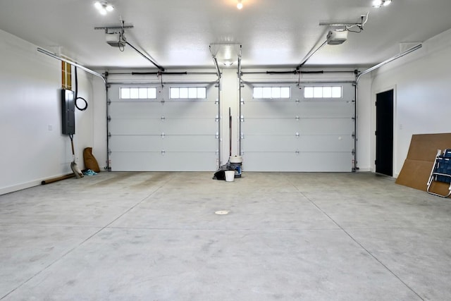 garage featuring electric panel and a garage door opener