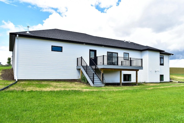 back of property with stairway, a lawn, and a deck