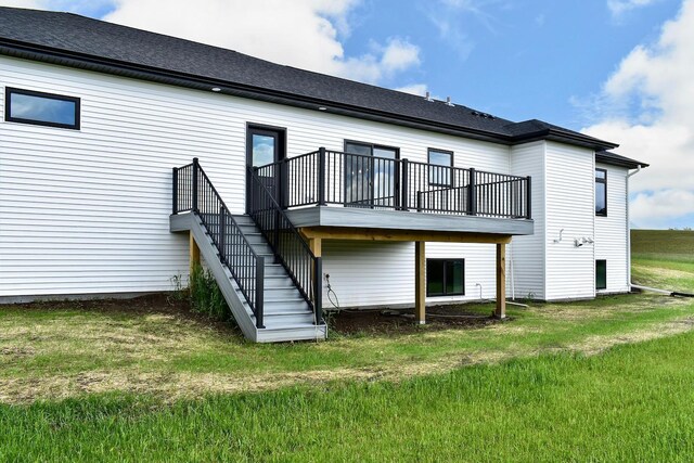 rear view of property featuring a wooden deck, stairs, and a yard