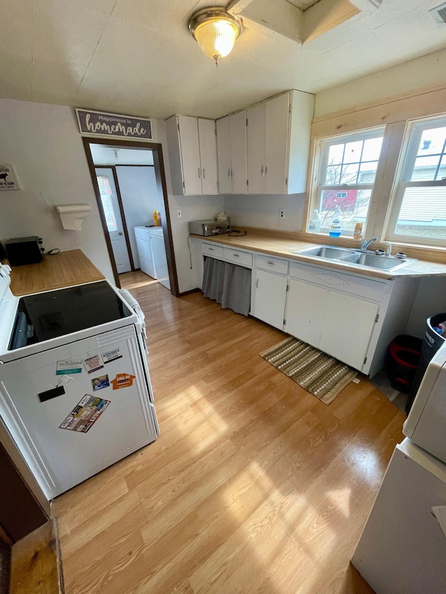 320 8th St SE, Staples, MN 56479 - kitchen with plenty of natural light, light wood-style flooring, and white cabinets