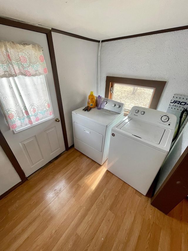 320 8th St SE, Staples, MN 56479 - washroom with washing machine and dryer and light wood-style floors