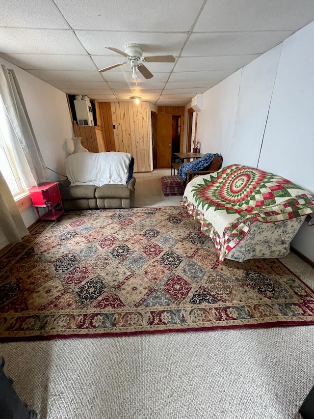 320 8th St SE, Staples, MN 56479 - living room with a drop ceiling, ceiling fan, carpet floors, and wood walls