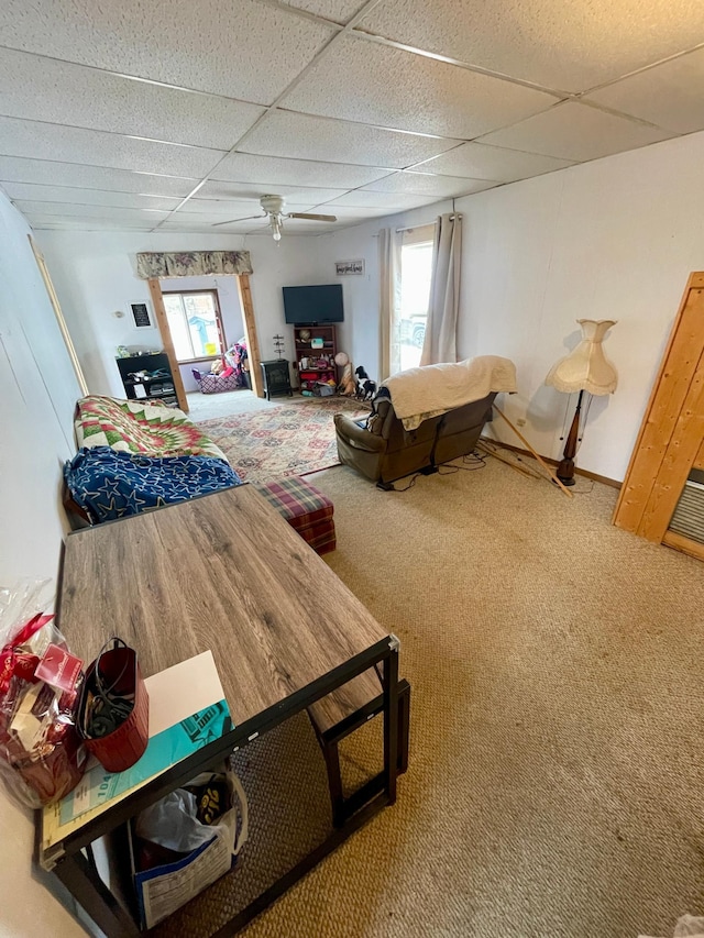 320 8th St SE, Staples, MN 56479 - carpeted living room with a paneled ceiling, healthy amount of natural light, and ceiling fan