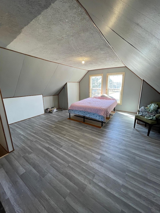 320 8th St SE, Staples, MN 56479 - bedroom featuring vaulted ceiling, wood finished floors, and a textured ceiling