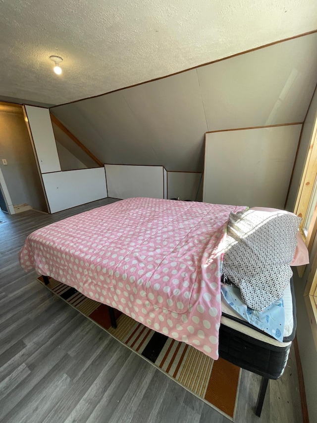320 8th St SE, Staples, MN 56479 - bedroom featuring wood finished floors, a textured ceiling, and lofted ceiling