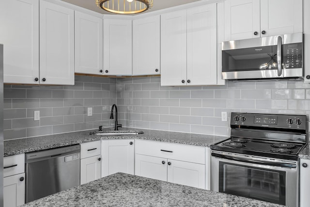 kitchen with a sink, stainless steel appliances, and white cabinets