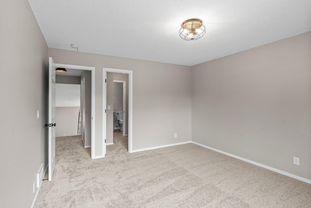 unfurnished bedroom with carpet and baseboards