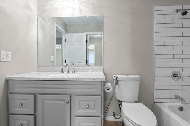 bathroom featuring vanity, toilet, and  shower combination
