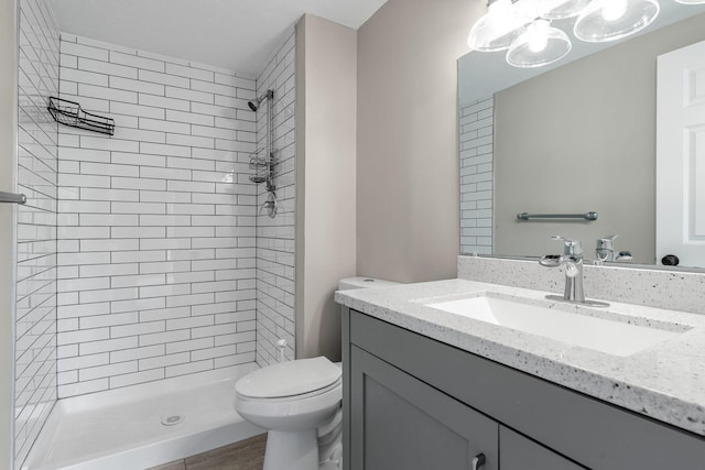 full bathroom featuring toilet, vanity, and a shower stall