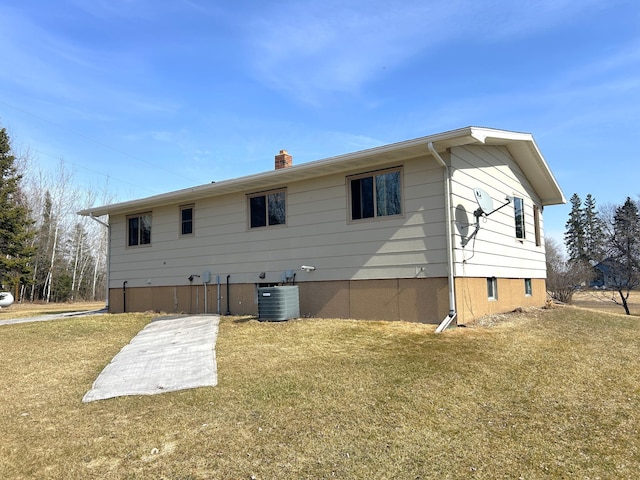 43475 310th Ave NE, Gatzke, MN 56724 - rear view of property featuring cooling unit, a yard, and a chimney