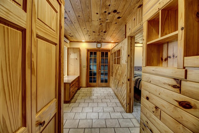 mudroom featuring light tile patterned floors, wooden ceiling, and french doors