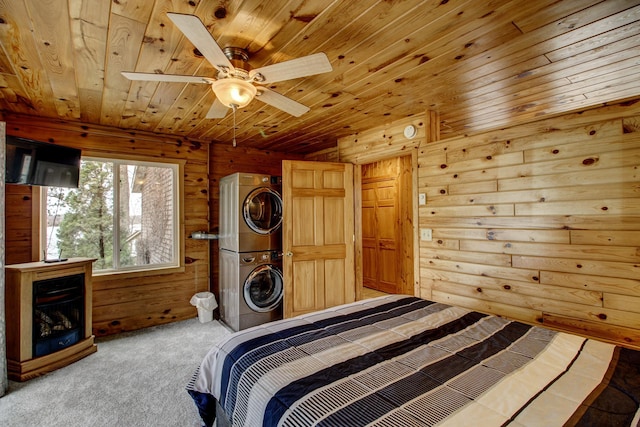 bedroom featuring wooden ceiling, stacked washer / drying machine, carpet flooring, and wood walls