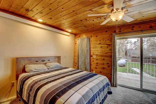bedroom featuring carpet flooring, wood walls, access to exterior, and wood ceiling
