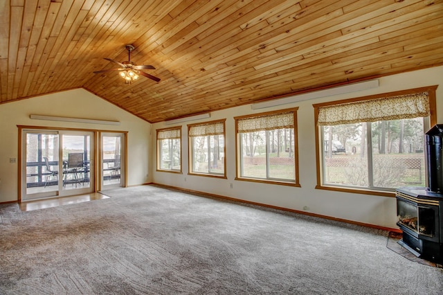 unfurnished living room with a wood stove, carpet, ceiling fan, and wood ceiling