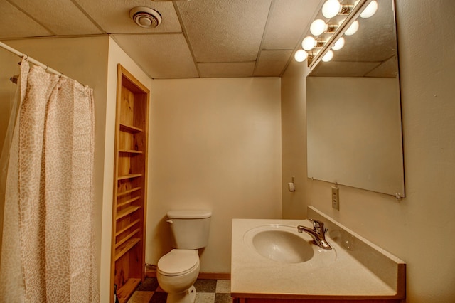 bathroom featuring vanity, toilet, a drop ceiling, curtained shower, and visible vents