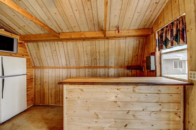 interior space featuring freestanding refrigerator, wood ceiling, and wood walls