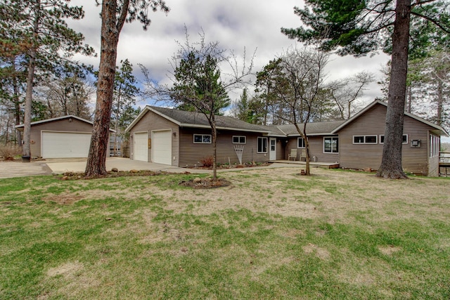 ranch-style home featuring an outdoor structure, a front lawn, and a detached garage