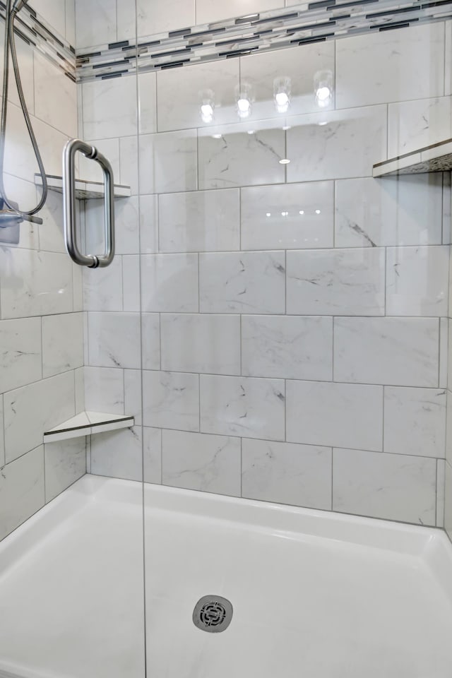full bath featuring a shower stall