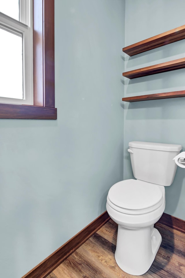 bathroom featuring baseboards, toilet, and wood finished floors