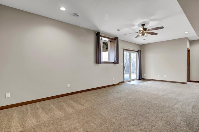 empty room featuring baseboards, visible vents, recessed lighting, ceiling fan, and light colored carpet