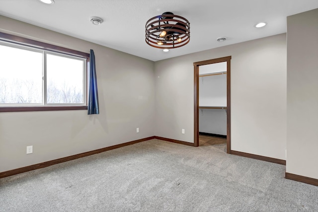carpeted spare room with recessed lighting and baseboards