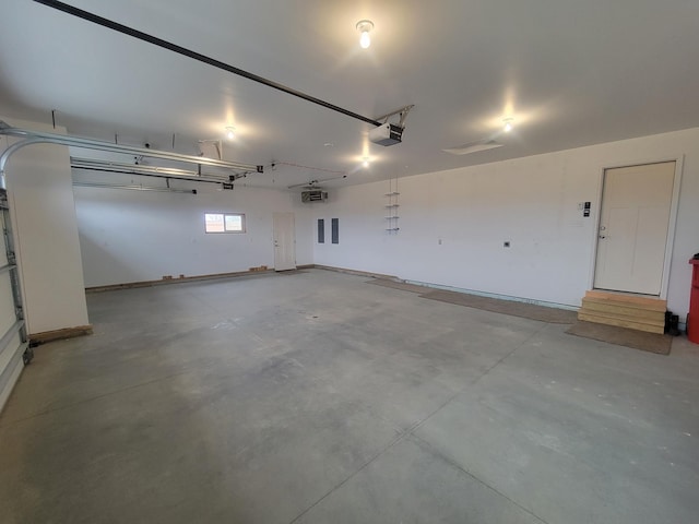garage featuring a garage door opener and baseboards