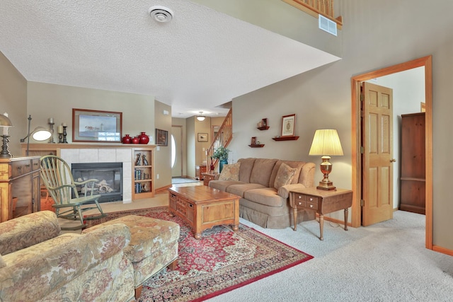 29561 Mentzer Ct, Lindstrom, MN 55045 - living room featuring carpet, a fireplace, and a textured ceiling