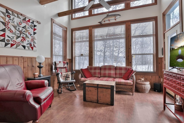 29561 Mentzer Ct, Lindstrom, MN 55045 - living area featuring a wainscoted wall, healthy amount of natural light, a ceiling fan, wood finished floors, and wood walls